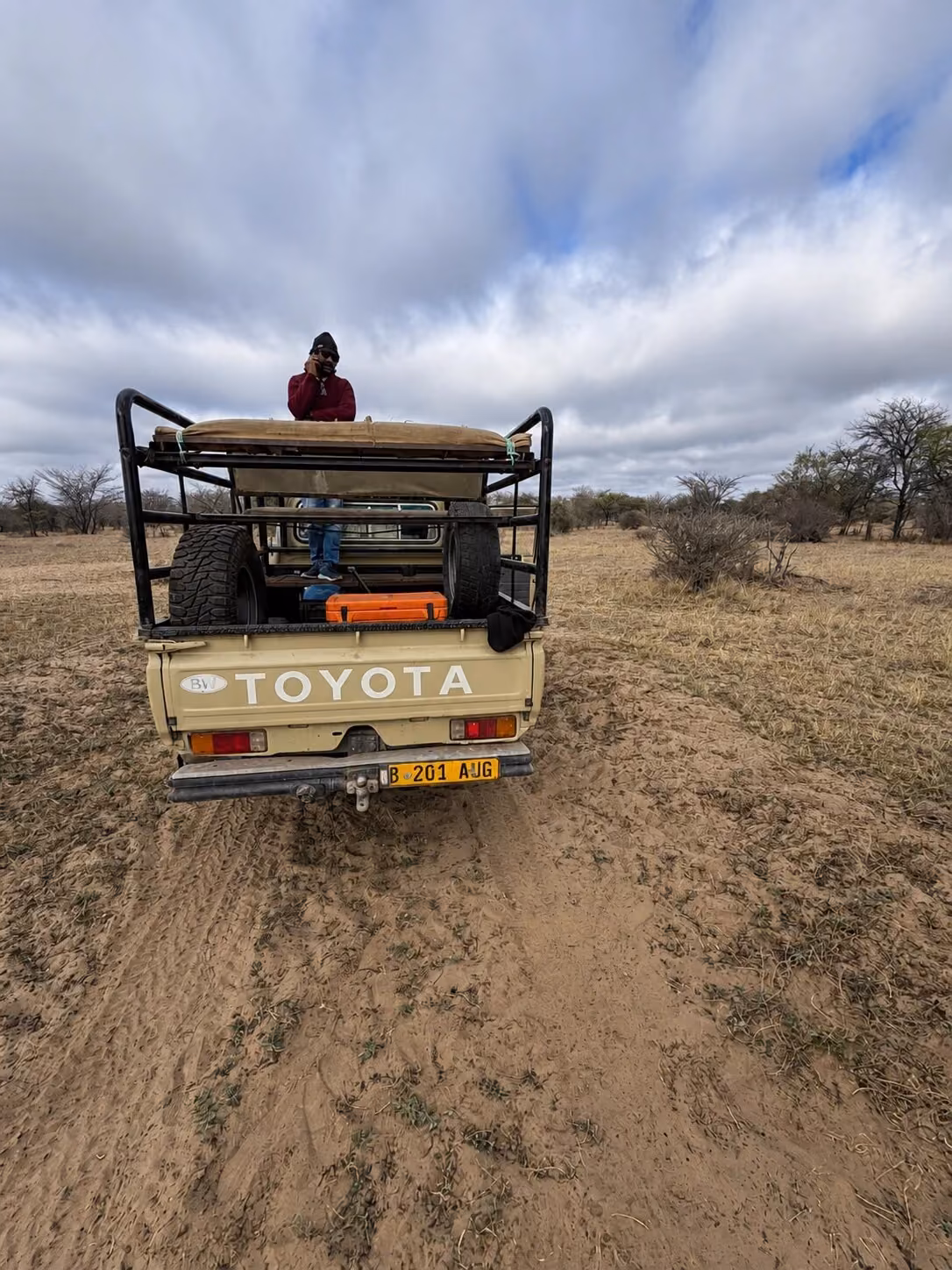 Safari vehicle crossing open Botswana hunting country